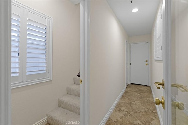 hall featuring baseboards and stairway