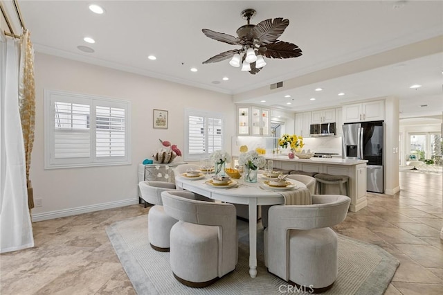 dining room with ceiling fan, ornamental molding, and recessed lighting