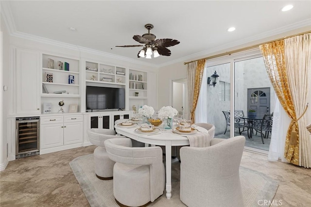 dining room with built in shelves, beverage cooler, a ceiling fan, ornamental molding, and recessed lighting