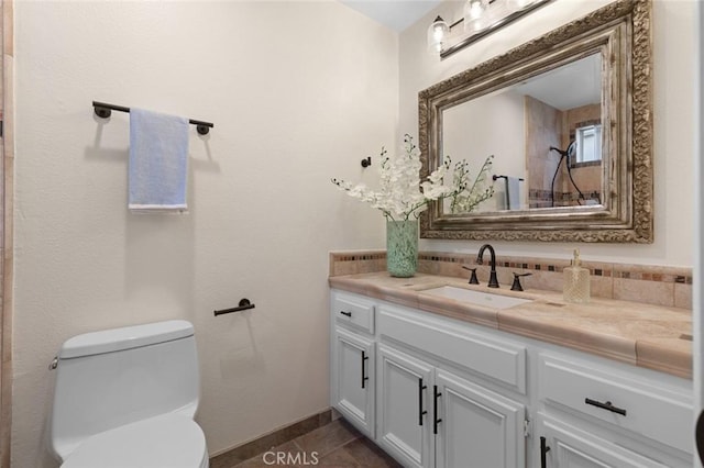 bathroom with toilet, tile patterned floors, and vanity