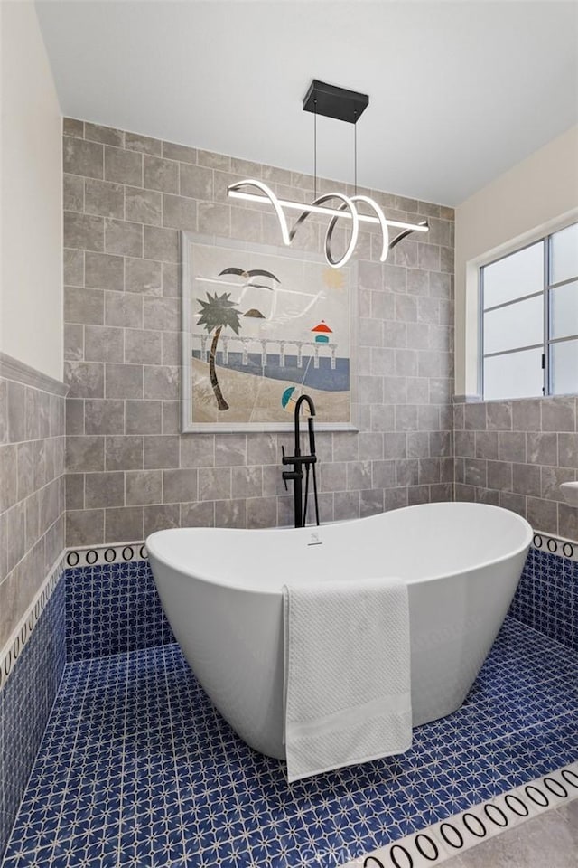bathroom featuring a tile shower, tile patterned floors, tile walls, and a soaking tub