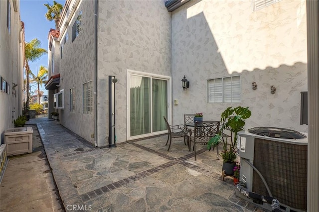 view of patio featuring outdoor dining space and central air condition unit