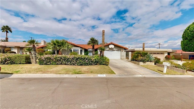 ranch-style house featuring driveway, a front lawn, a garage, and fence