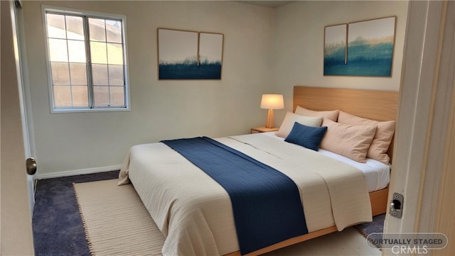 bedroom with carpet flooring and baseboards