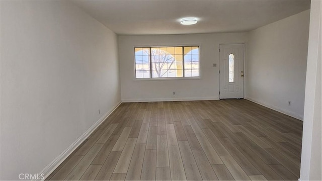 entrance foyer with baseboards and wood finished floors