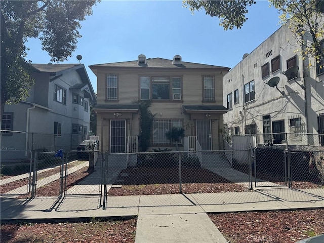 view of front of property with a fenced front yard and a gate