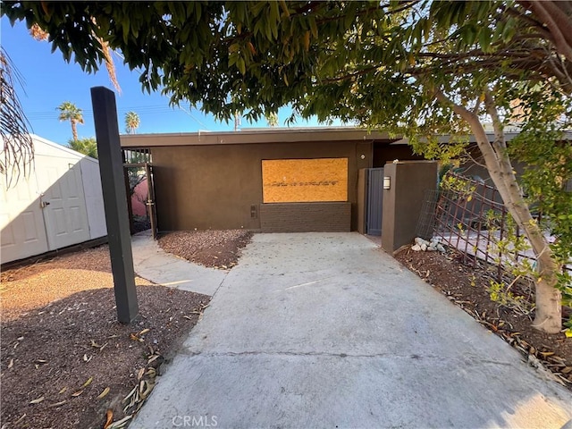 view of home's exterior with fence and stucco siding