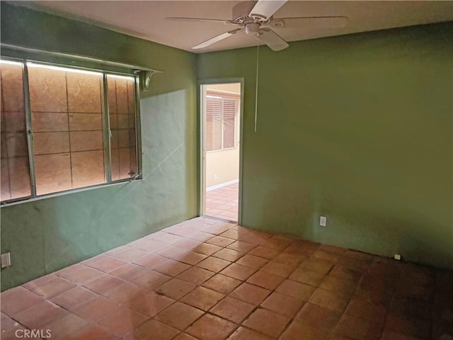 unfurnished room with tile patterned flooring and ceiling fan