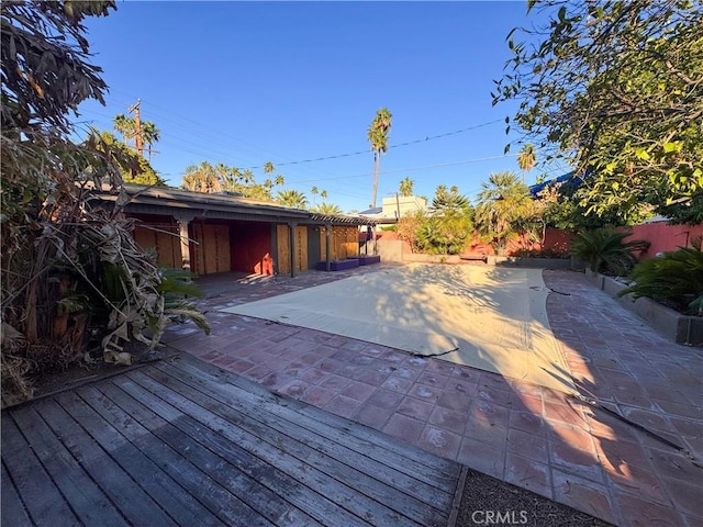 wooden terrace with a patio area and a fenced backyard