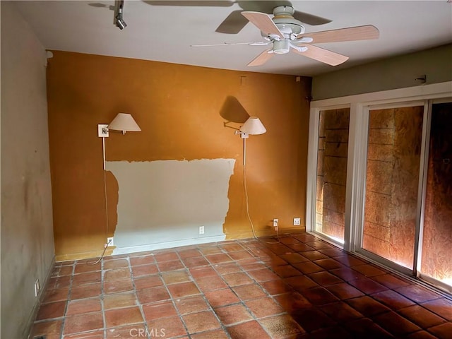 spare room featuring tile patterned flooring and a ceiling fan