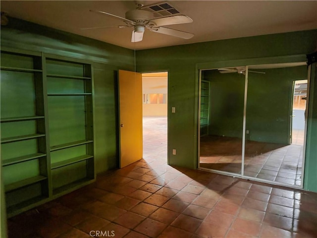 unfurnished room featuring a ceiling fan, visible vents, and tile patterned floors