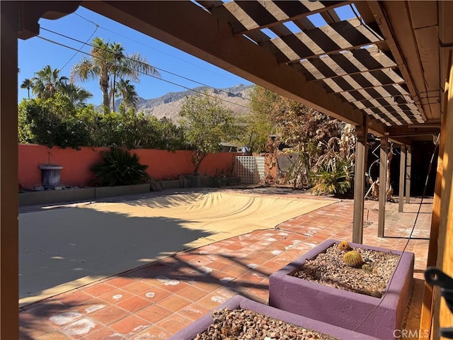 view of patio / terrace featuring a fenced backyard, a mountain view, and a pergola