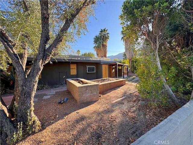 back of house featuring stucco siding