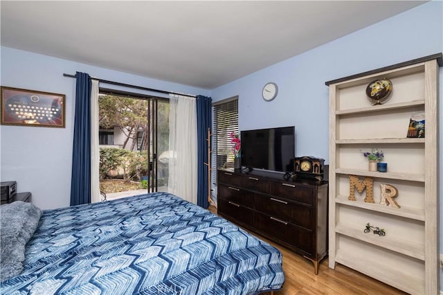 bedroom with access to exterior and light wood finished floors