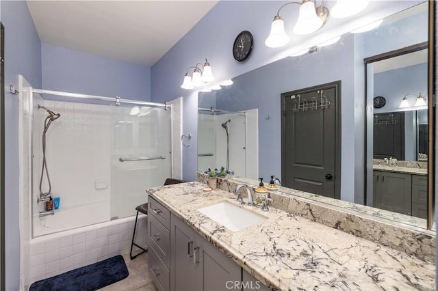 full bath featuring tiled shower / bath and vanity