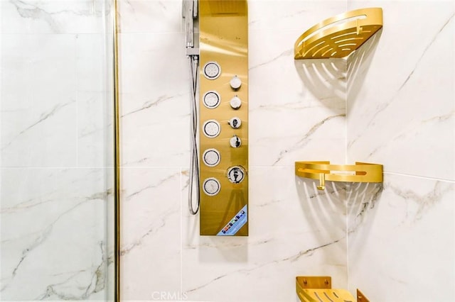 bathroom view of a marble finish shower