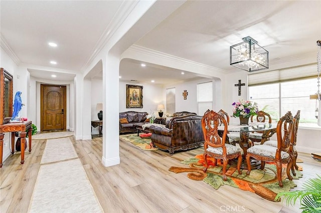dining area featuring light wood-style floors, a chandelier, recessed lighting, ornamental molding, and baseboards