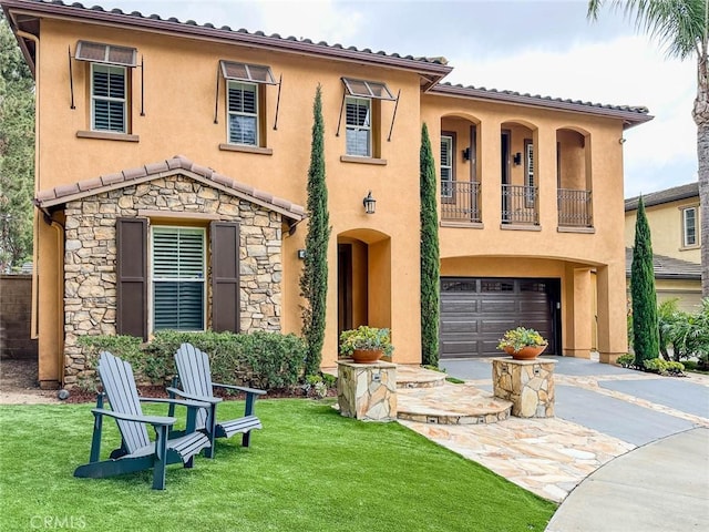 mediterranean / spanish home featuring a balcony, stone siding, driveway, and stucco siding