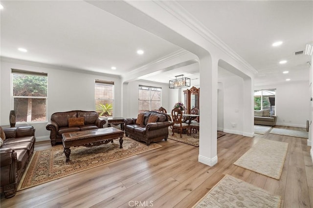 living area with a chandelier, crown molding, light wood-type flooring, recessed lighting, and baseboards