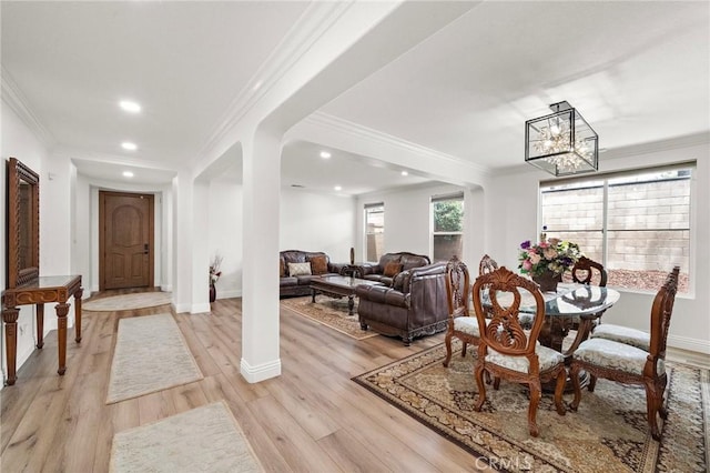 dining area featuring a chandelier, light wood-type flooring, crown molding, baseboards, and recessed lighting