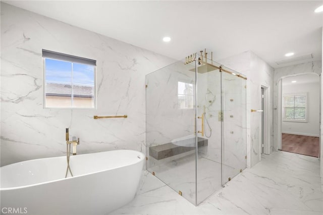 full bathroom featuring a marble finish shower, a soaking tub, recessed lighting, and marble finish floors