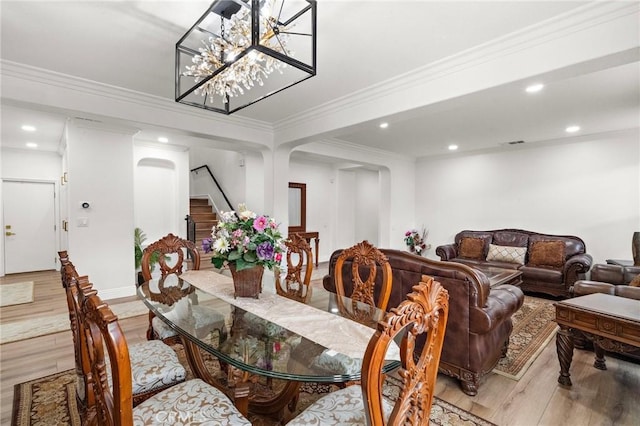 dining area featuring stairs, light wood-style floors, recessed lighting, crown molding, and a chandelier