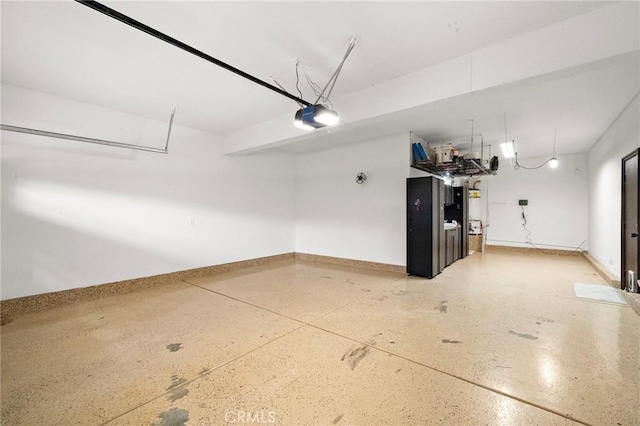 garage with a garage door opener and baseboards