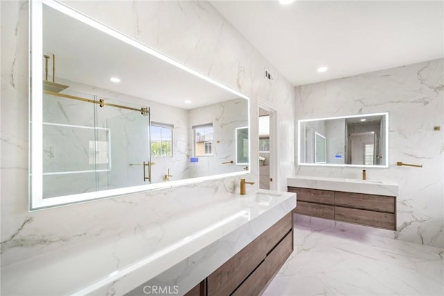bathroom with a marble finish shower, marble tiled flooring, vanity, and recessed lighting