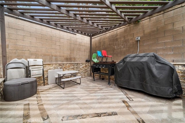view of patio / terrace with area for grilling and a pergola