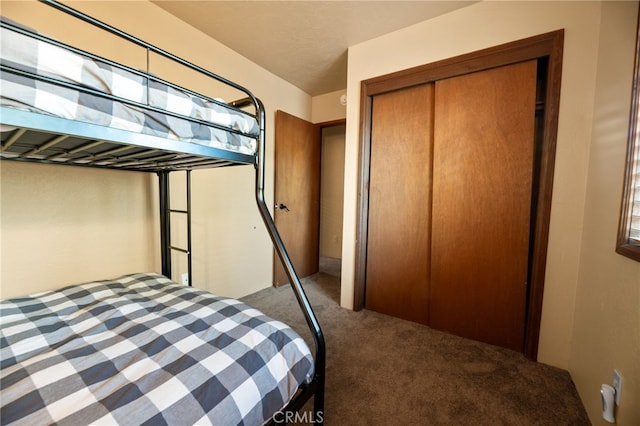 bedroom with carpet floors and a closet