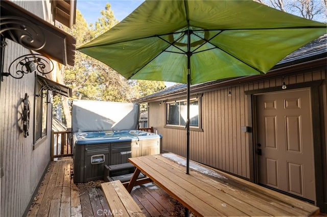 wooden deck featuring a hot tub