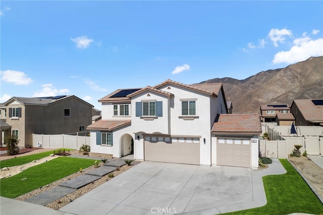 view of front of house with stucco siding, a front yard, fence, and a tiled roof