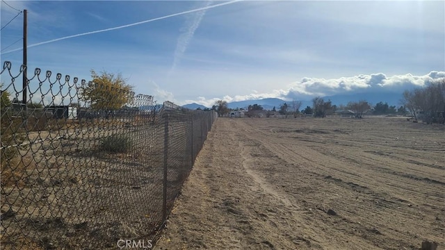 view of street with a rural view and a mountain view