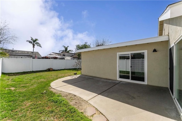 view of yard with fence and a patio