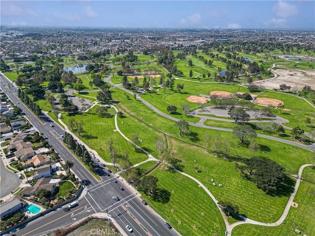 birds eye view of property with a water view and golf course view