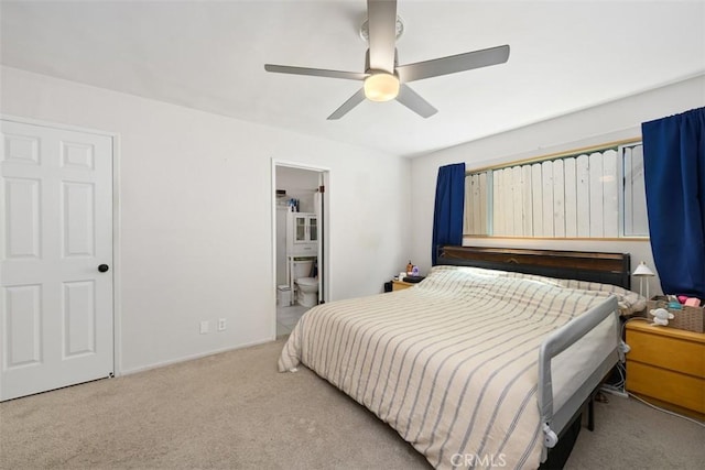 carpeted bedroom with ceiling fan and ensuite bathroom