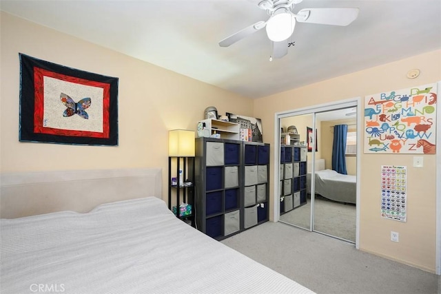 carpeted bedroom featuring a closet and ceiling fan