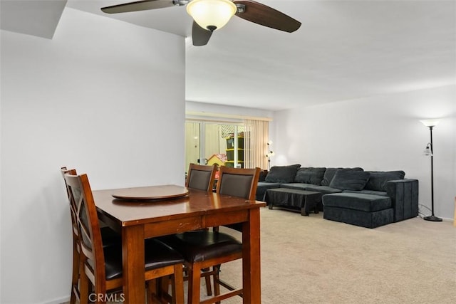 carpeted dining space featuring ceiling fan