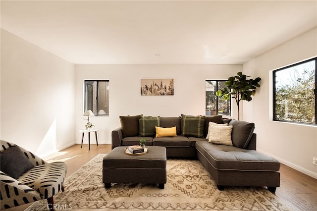 living room featuring light wood-style flooring and baseboards