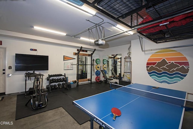 recreation room featuring a garage and strapped water heater