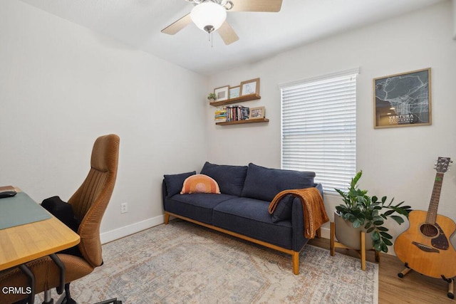 office area featuring a ceiling fan, baseboards, and wood finished floors