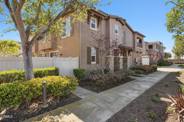 exterior space featuring fence and stucco siding