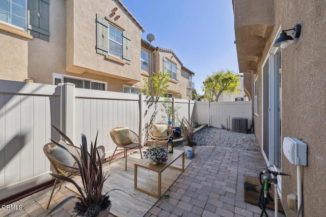 view of patio with central AC unit and a fenced backyard