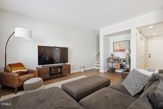 living room with recessed lighting, visible vents, stairway, wood finished floors, and baseboards