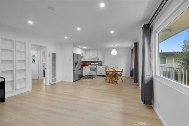 kitchen featuring light wood-style floors, recessed lighting, white appliances, and white cabinetry