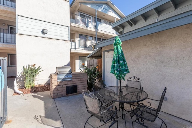 view of patio with outdoor dining area and area for grilling