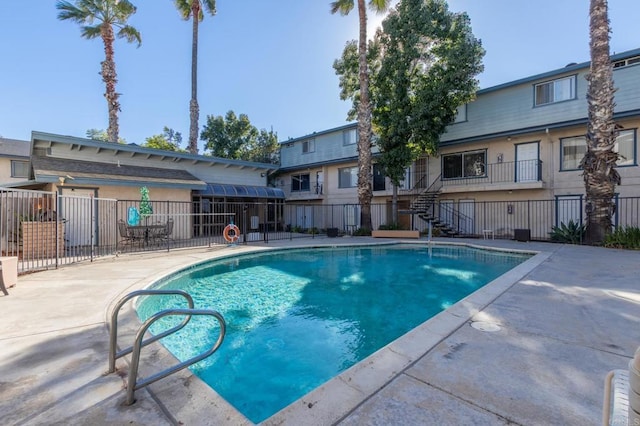 view of pool featuring a fenced in pool, fence, and a patio