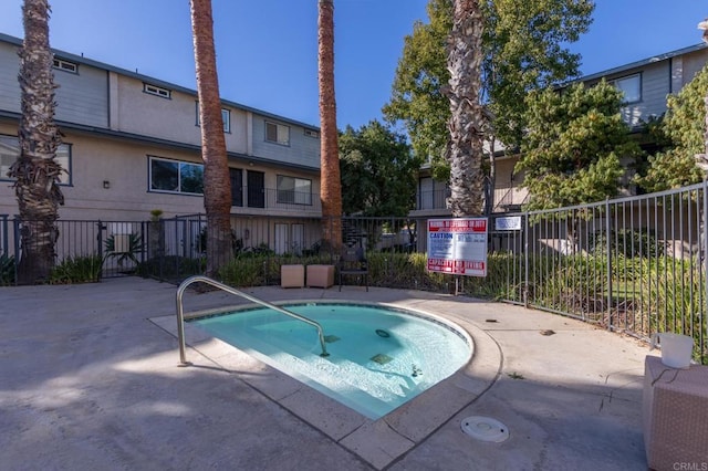 view of pool featuring fence