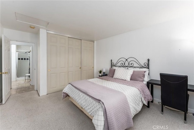 bedroom with a closet and light colored carpet