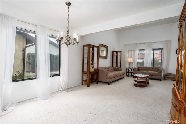 sitting room with an inviting chandelier and light colored carpet